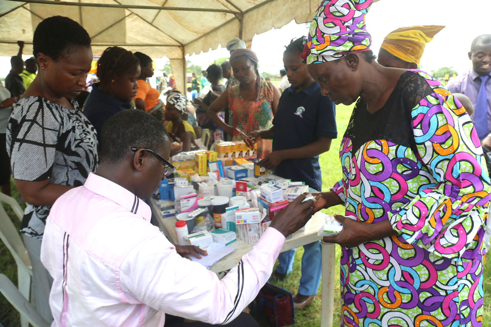 A pharmacist from Covenant University Health Centre, dipspensing some drugs to a beneficiary at one of Covenant University's community impact outreach at Iju