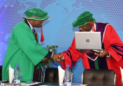 Vice-Chancellor, Professor Abiodun H. Adebayo, congratulating Professor Emeka Iweala