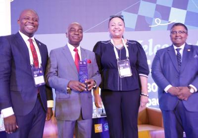 The Chancellor Covenant University Dr David Oyedepo Receiving An Award Plaque From Ms Veronica Omeni The Principal Consultant And Chairperson Qs Quacquarelli Symonds United Kingdom